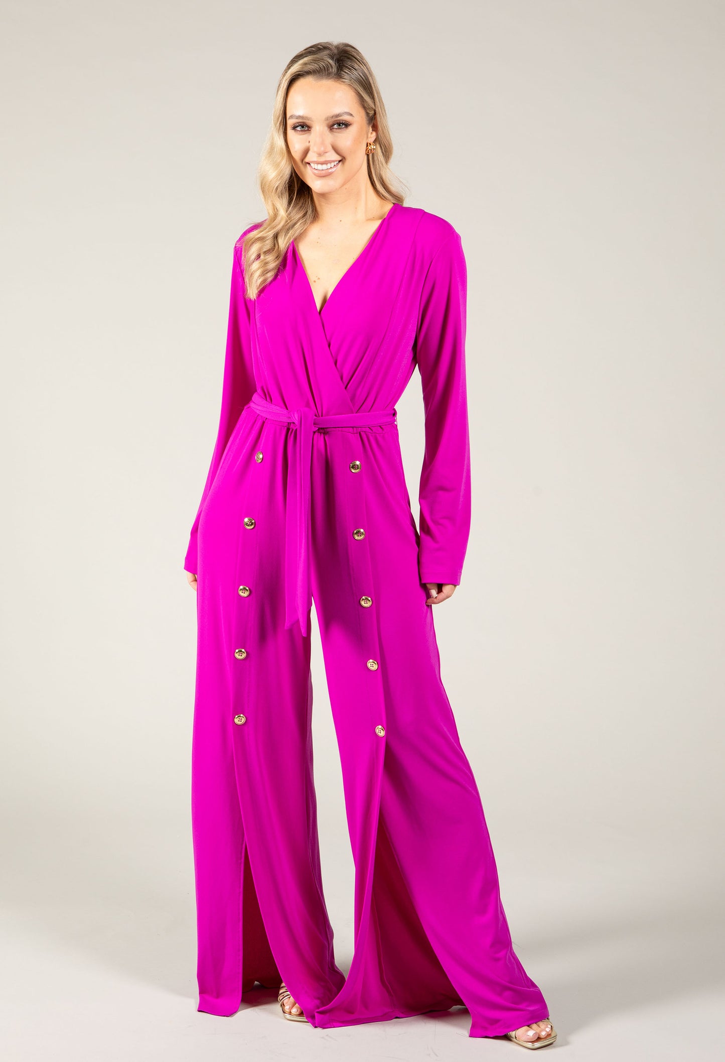 woman wearing magenta jumpsuit with gold buttons