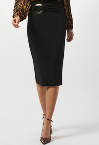 Person wearing a black pencil skirt with a belt and leopard print top and shoes on a white background