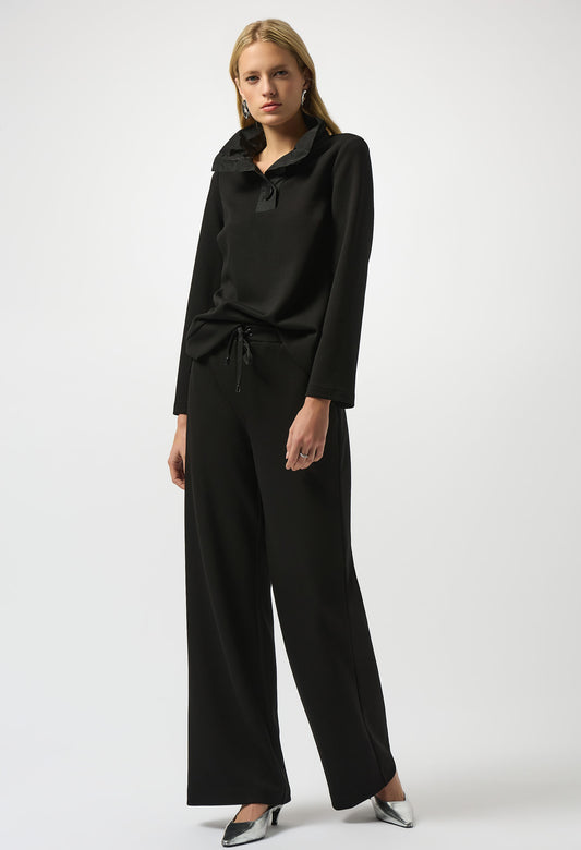 Woman wearing a black outfit on a white background