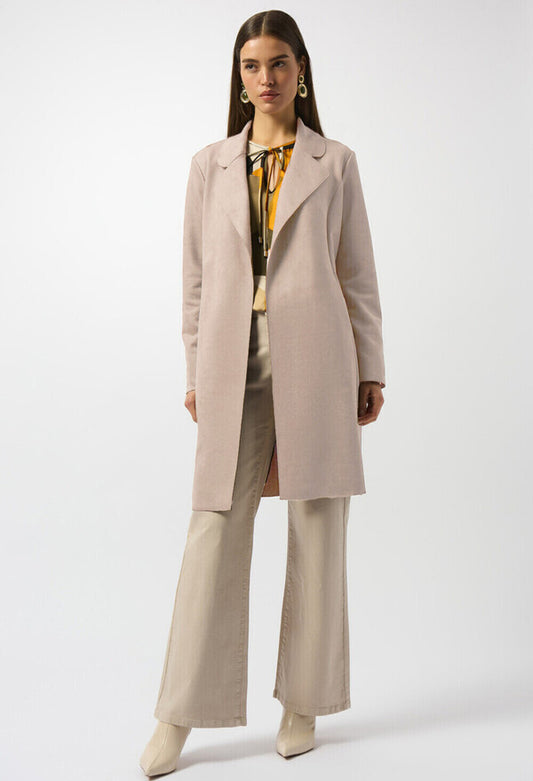 Woman wearing a beige trench coat on a gray background