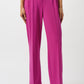 Fuchsia pants worn by a person on a white background