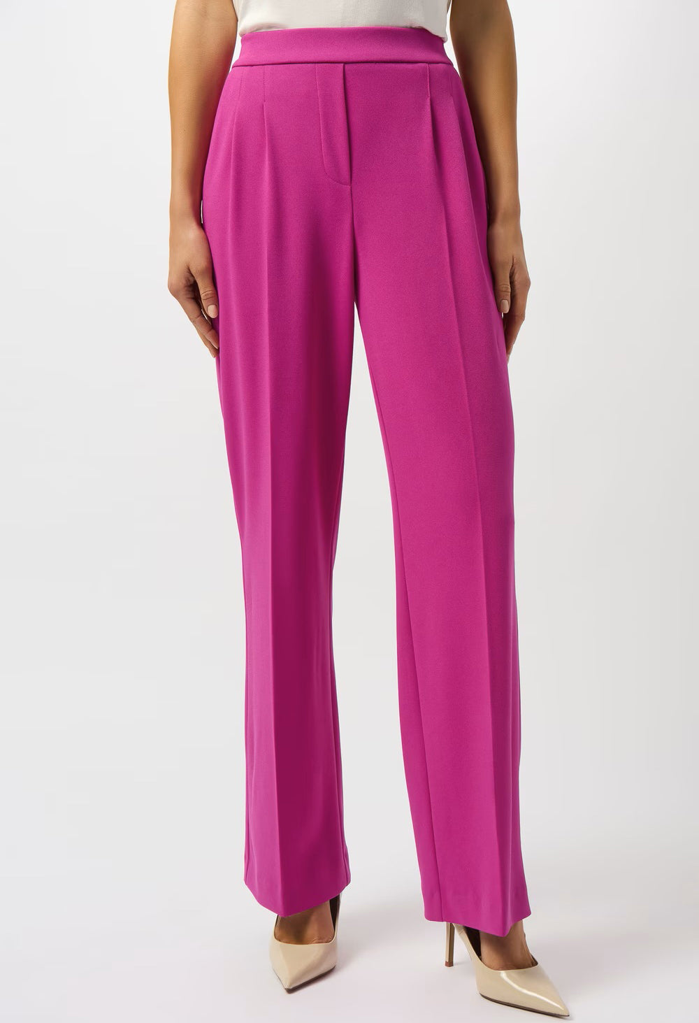 Fuchsia pants worn by a person on a white background