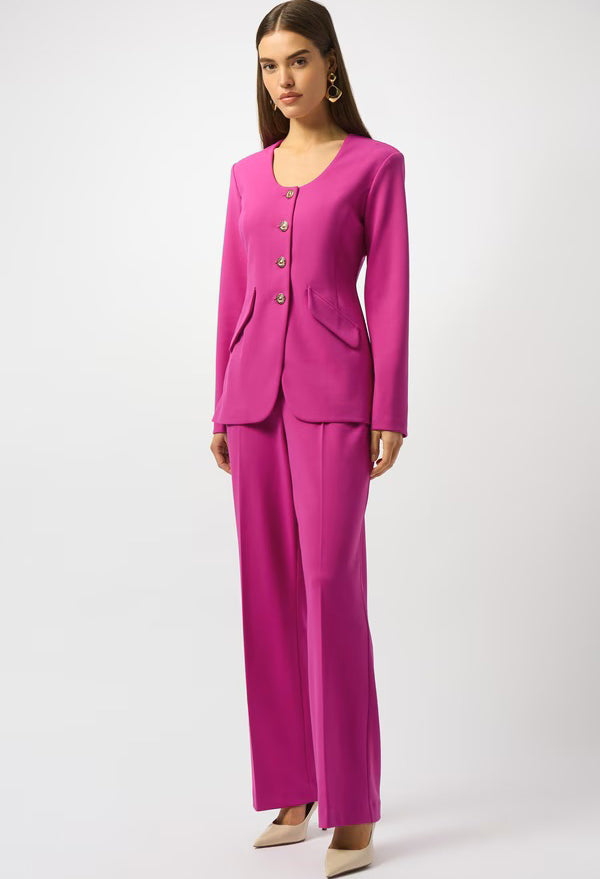 Woman wearing a bright pink suit on a white background