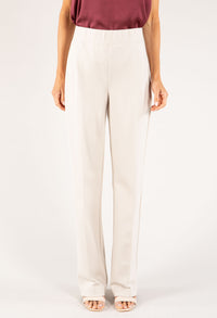 Person wearing white pants on a plain background