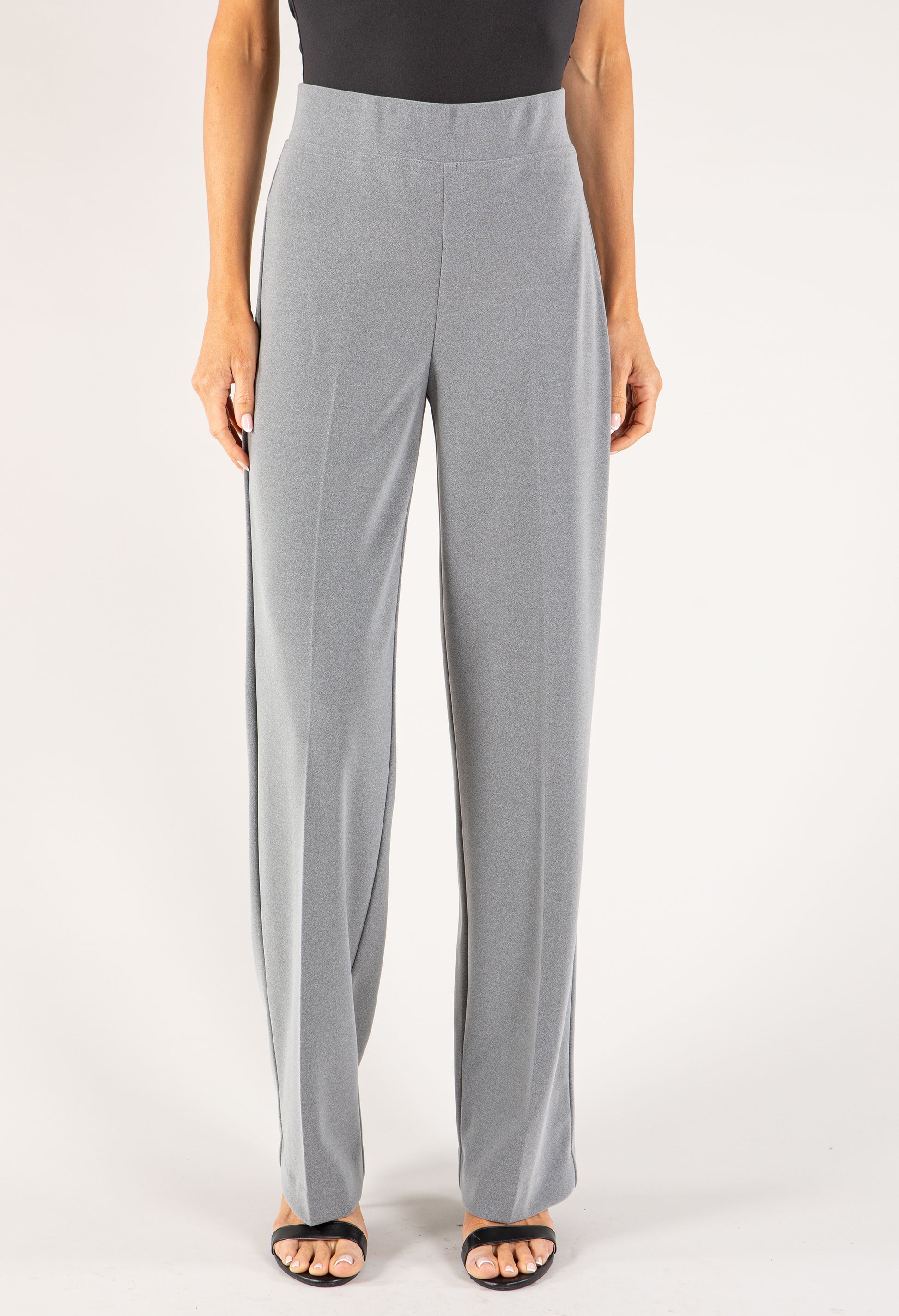 Gray pants worn by a person on a white background