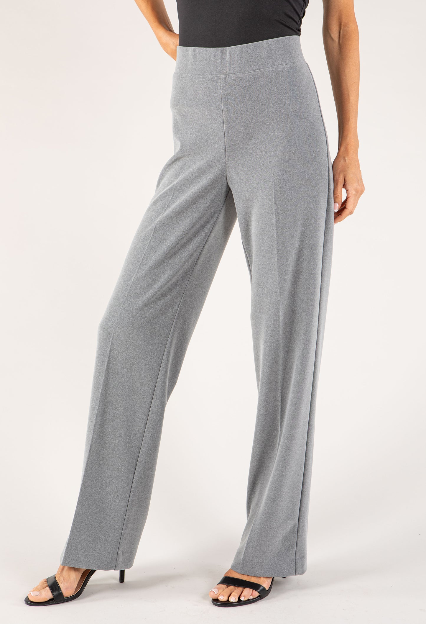 Gray pants worn by a person on a white background