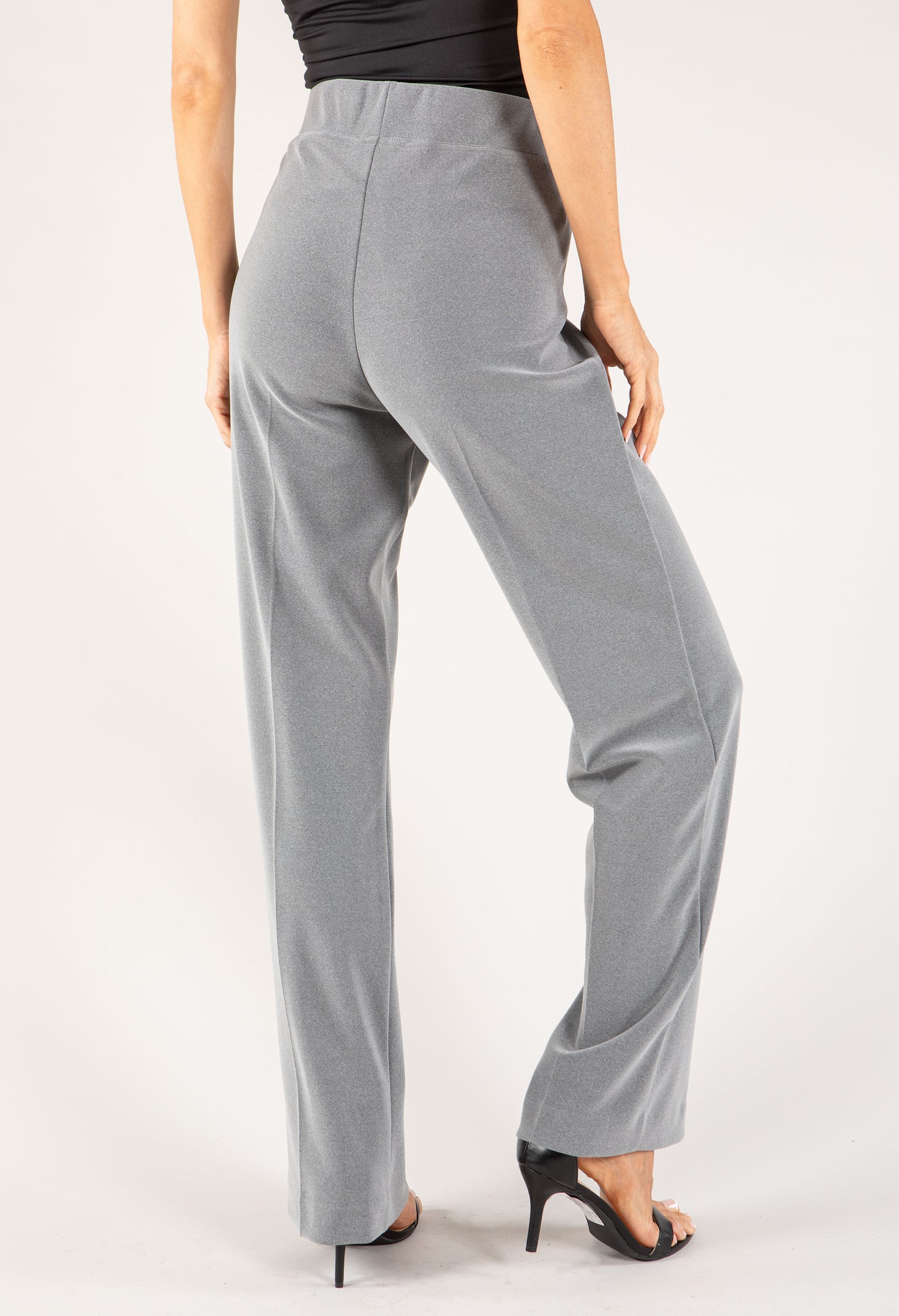 Gray pants worn by a person on a white background