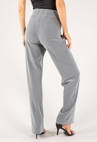 Gray pants worn by a person on a white background