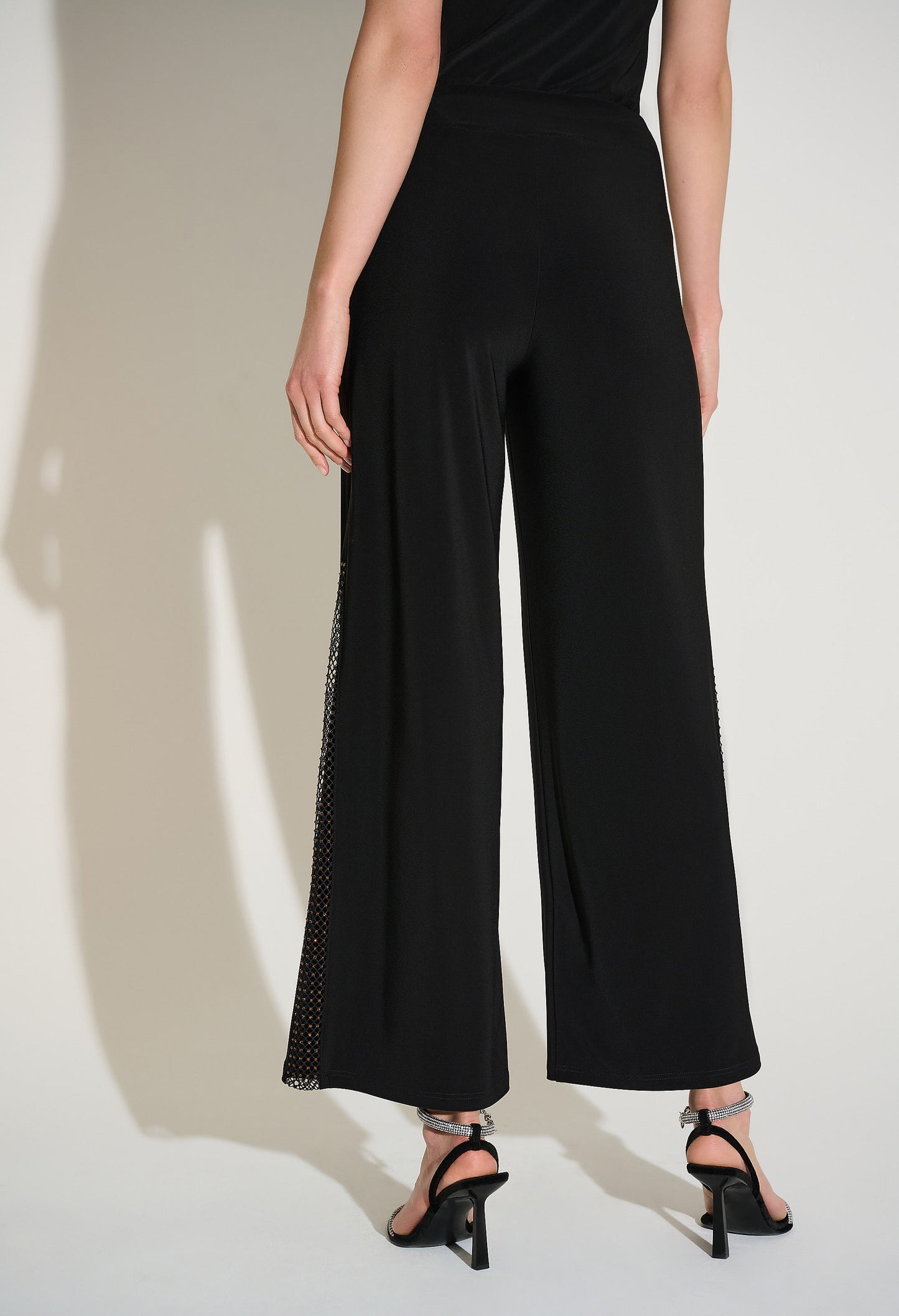 Black wide-leg pants worn by a person on a plain background