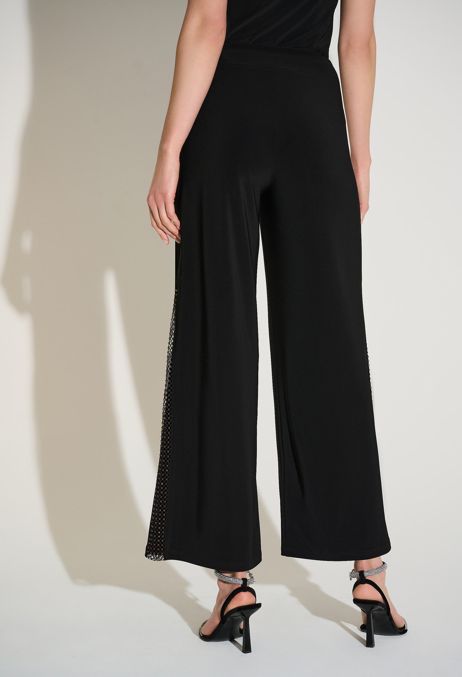 Black wide-leg pants worn by a person on a plain background