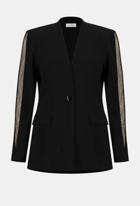 Black blazer with sheer sleeves on a light gray background