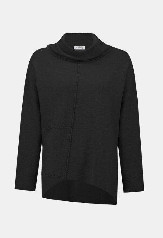 Woman wearing a white cowl-neck sweater and black pants on a white background