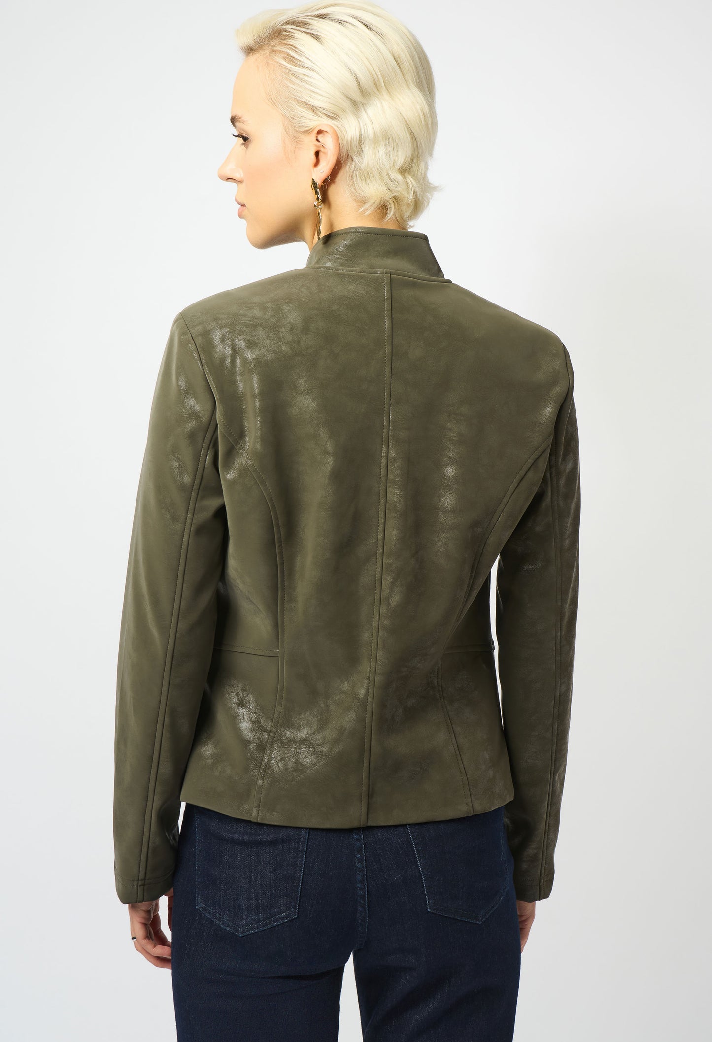 Person wearing a green leather jacket on a white background