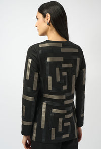 Woman wearing a black jacket with geometric patterns on a white background