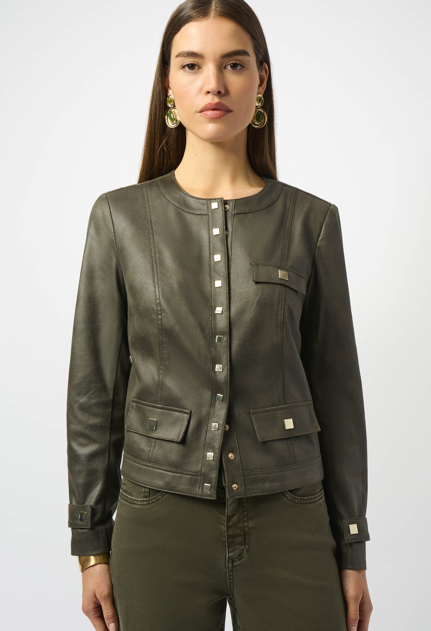 Woman wearing an olive green jacket and pants on a white background