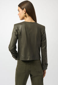 Woman wearing a green leather jacket and pants on a white background
