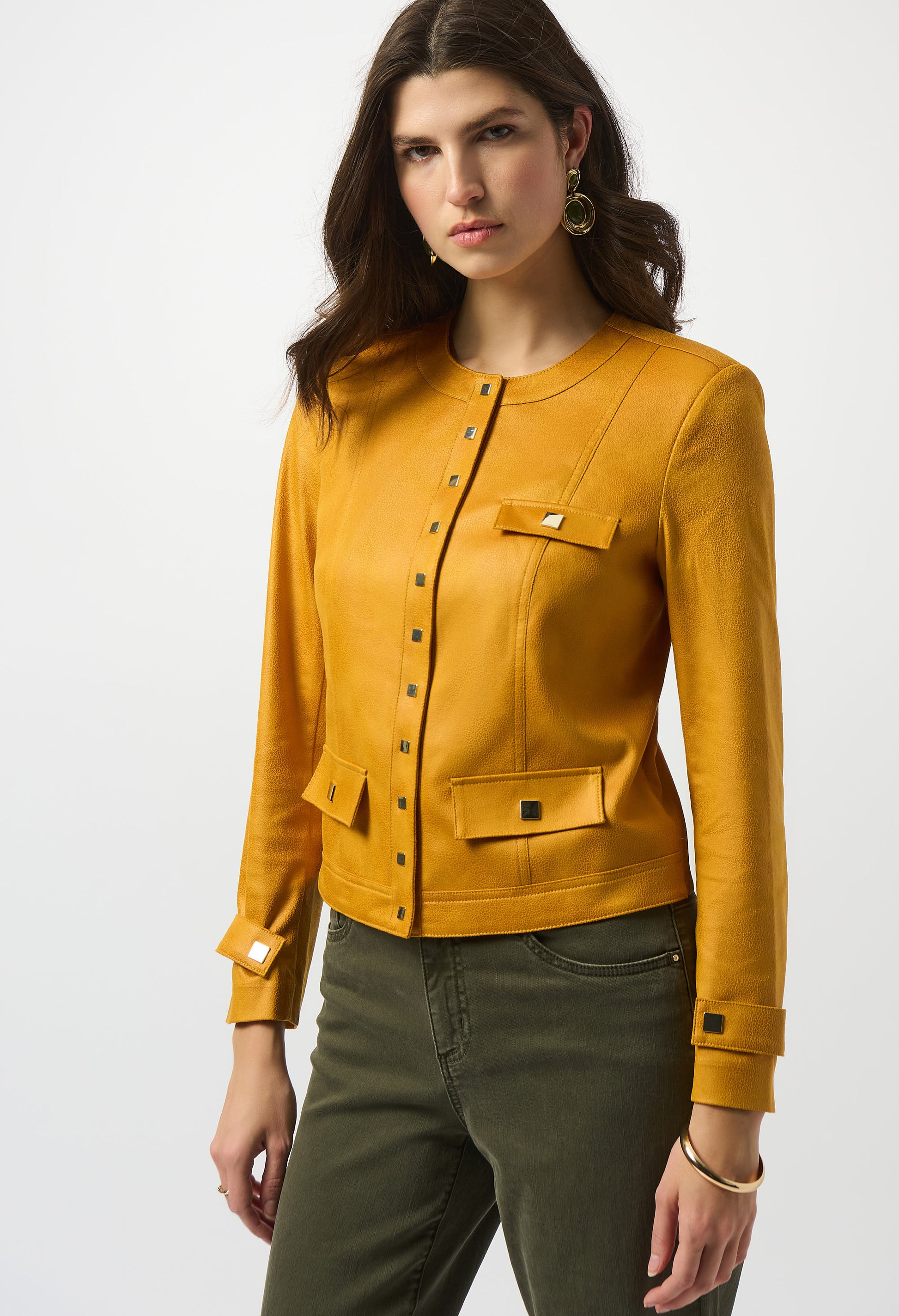 Woman wearing a mustard yellow jacket on a white background
