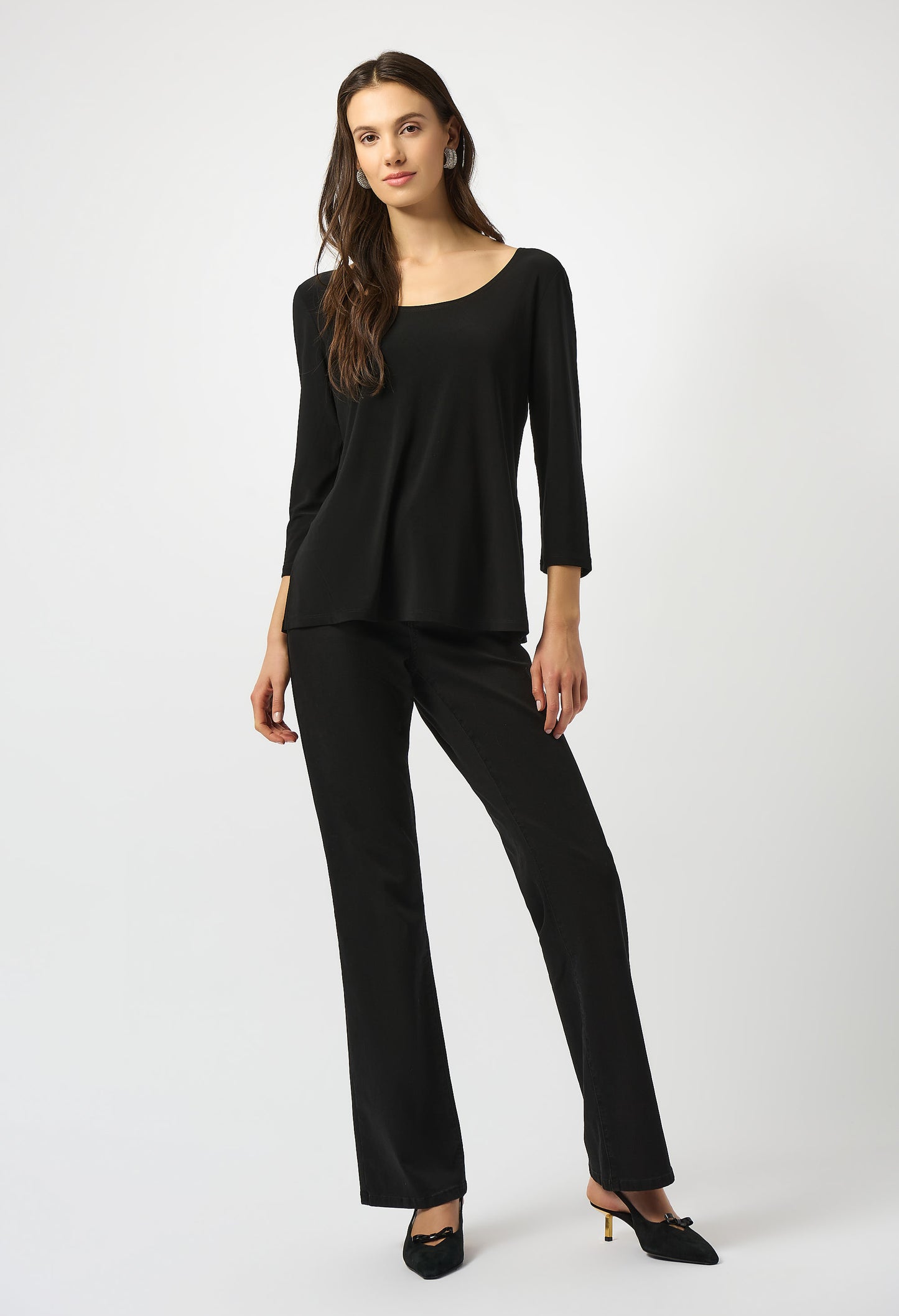 Woman wearing a black outfit on a white background