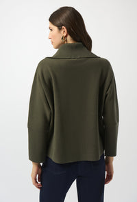 Person wearing an olive green jacket on a white background