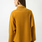 Person wearing a mustard yellow sweater on a white background