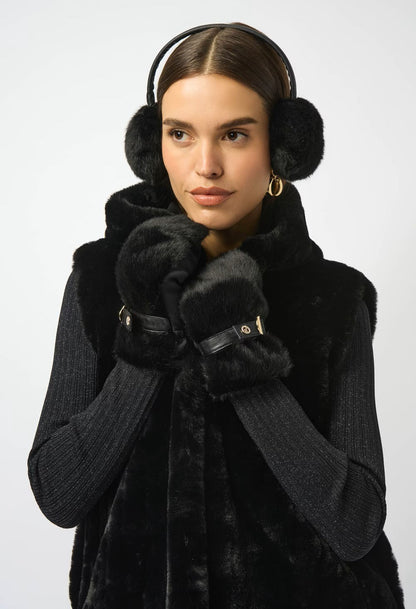 Woman wearing a black coat, gloves, and earmuffs on a white background