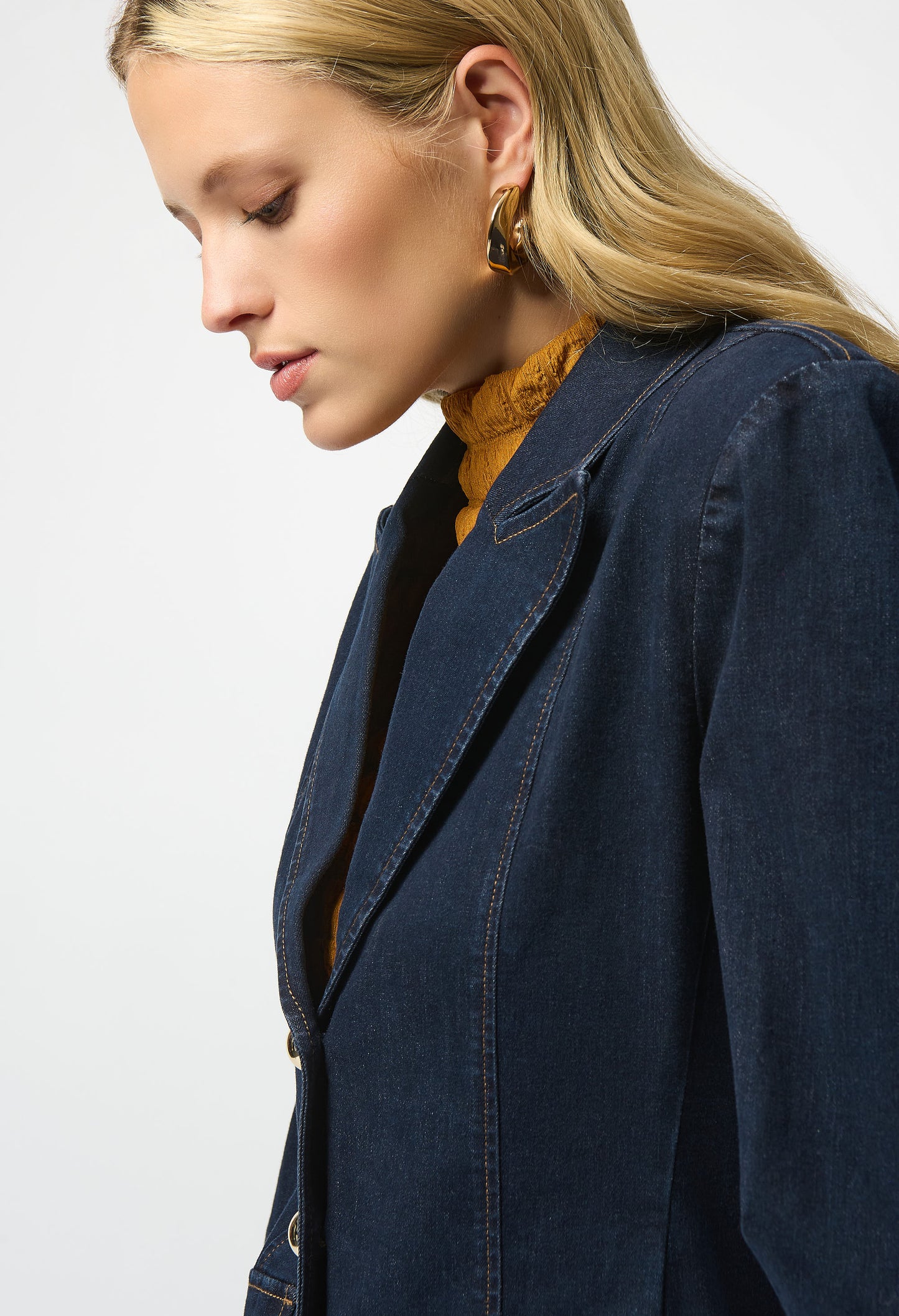 Person wearing a navy blue jacket on a plain background