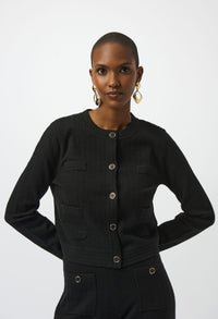 Woman wearing a black jacket with silver buttons on a white background