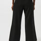 Black wide-leg pants worn by a person on a white background