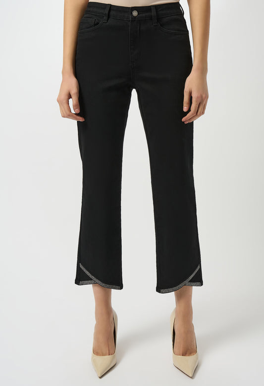 Black pants worn by a person on a white background