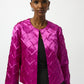 Woman wearing a bright pink quilted jacket on a white background