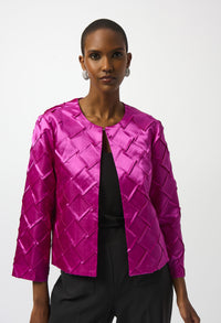 Woman wearing a bright pink quilted jacket on a white background
