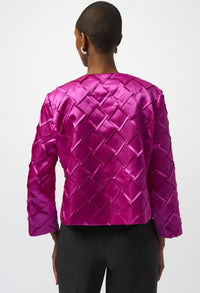Person wearing a bright pink quilted jacket on a white background