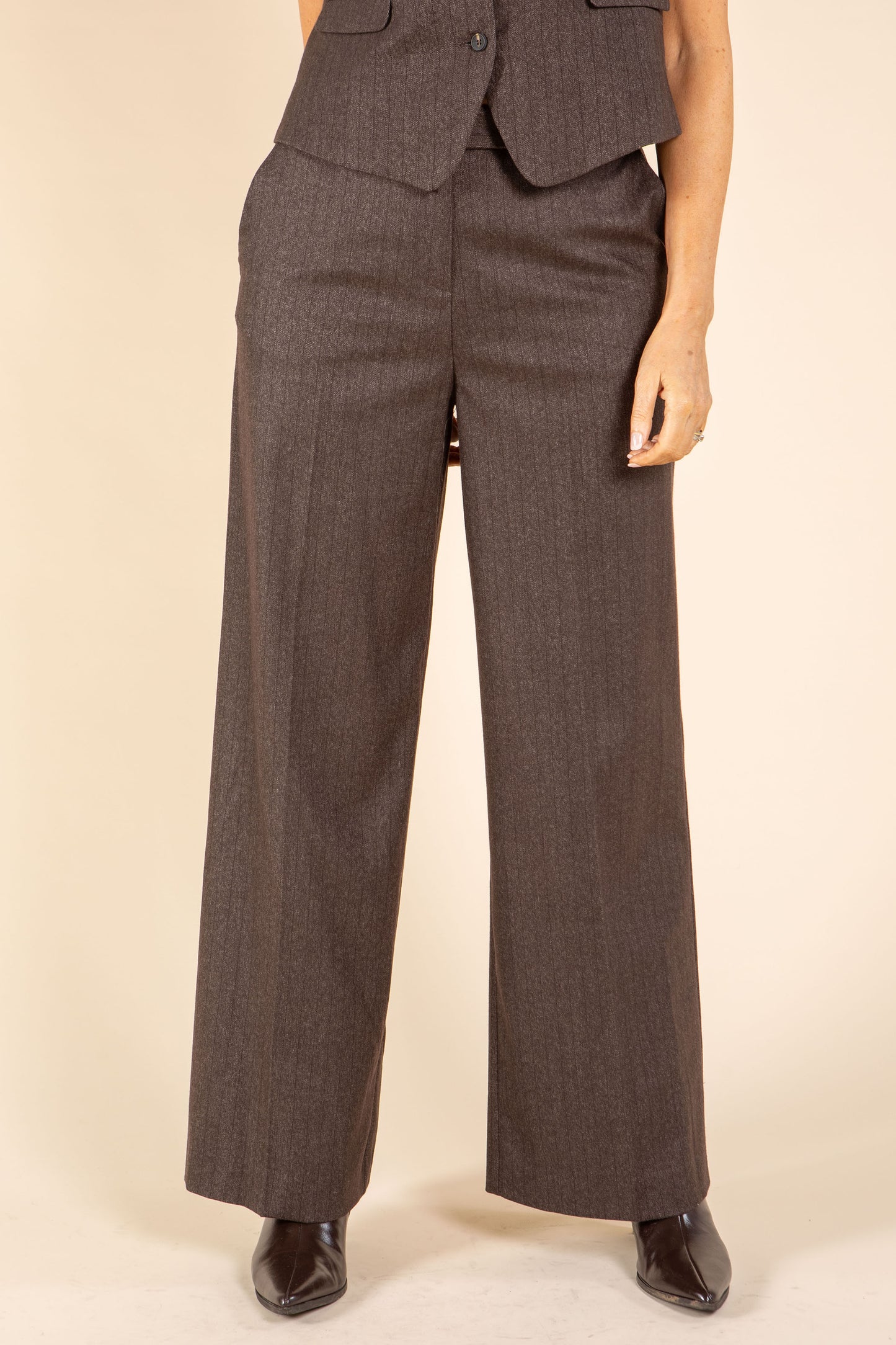 Brown suit with wide-leg pants on a beige background