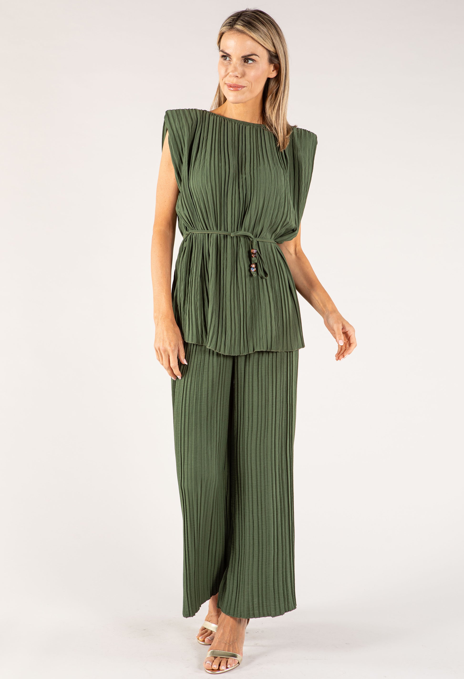 Woman wearing a green jumpsuit on a white background