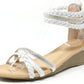 Beige wedge sandal with white braided straps on a white background