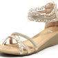 Beige wedge sandal with braided straps on a white background