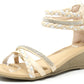 Beige wedge sandal with braided straps and rhinestones on a white background