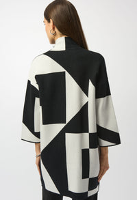 Woman wearing a black and white geometric patterned outfit on a plain background