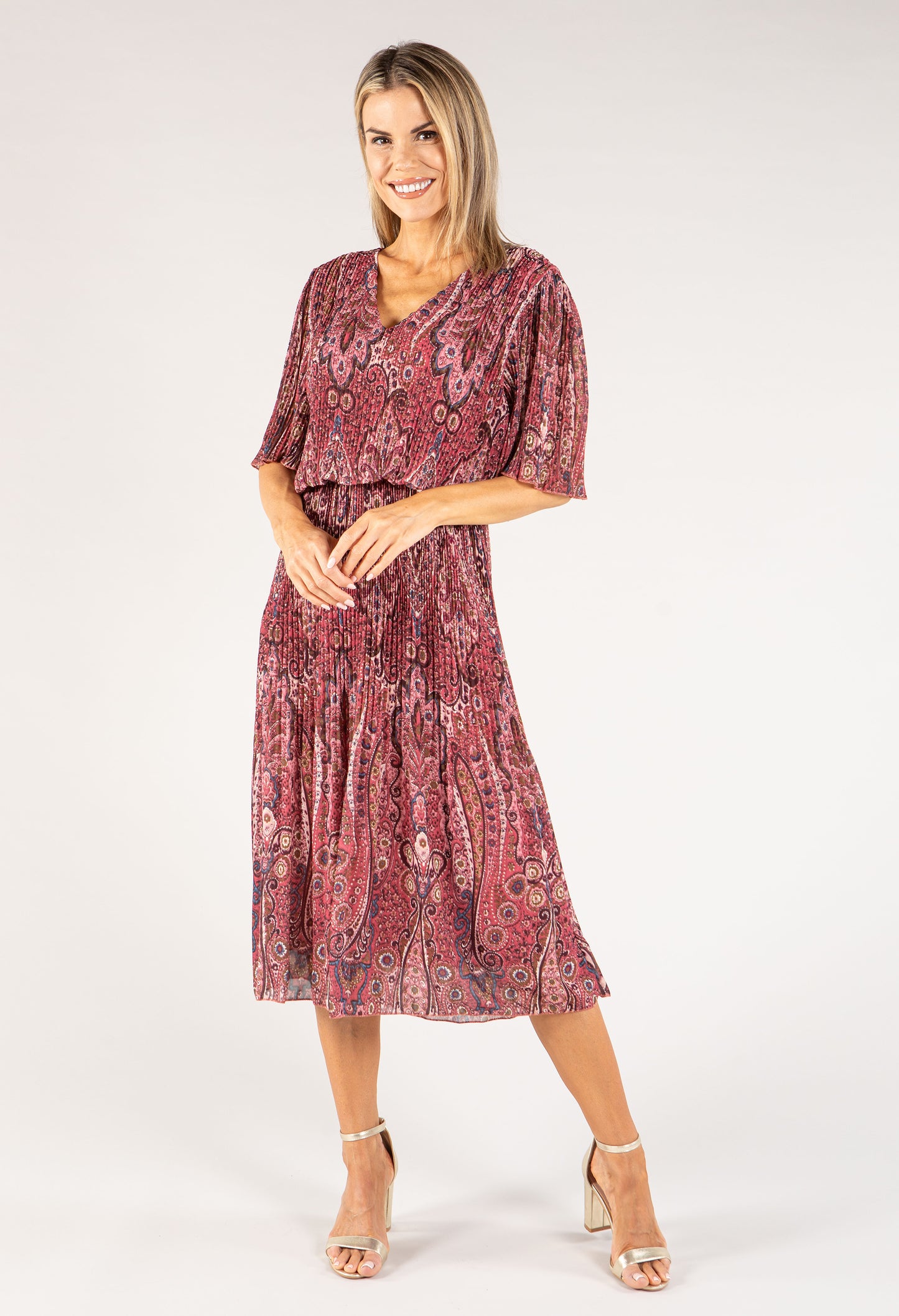 Woman wearing a patterned dress on a white background