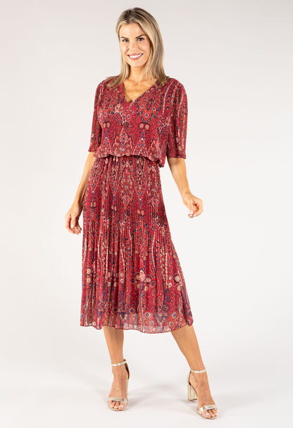 Woman wearing a red floral dress on a white background
