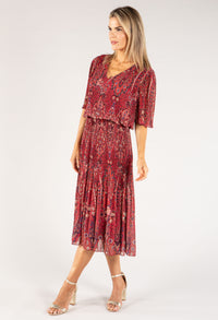 Woman wearing a red floral dress on a white background