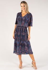 Woman wearing a blue patterned dress on a white background