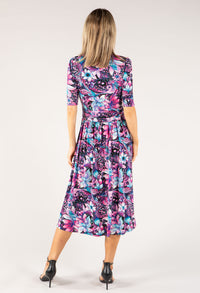 Woman wearing a colorful floral dress on a white background