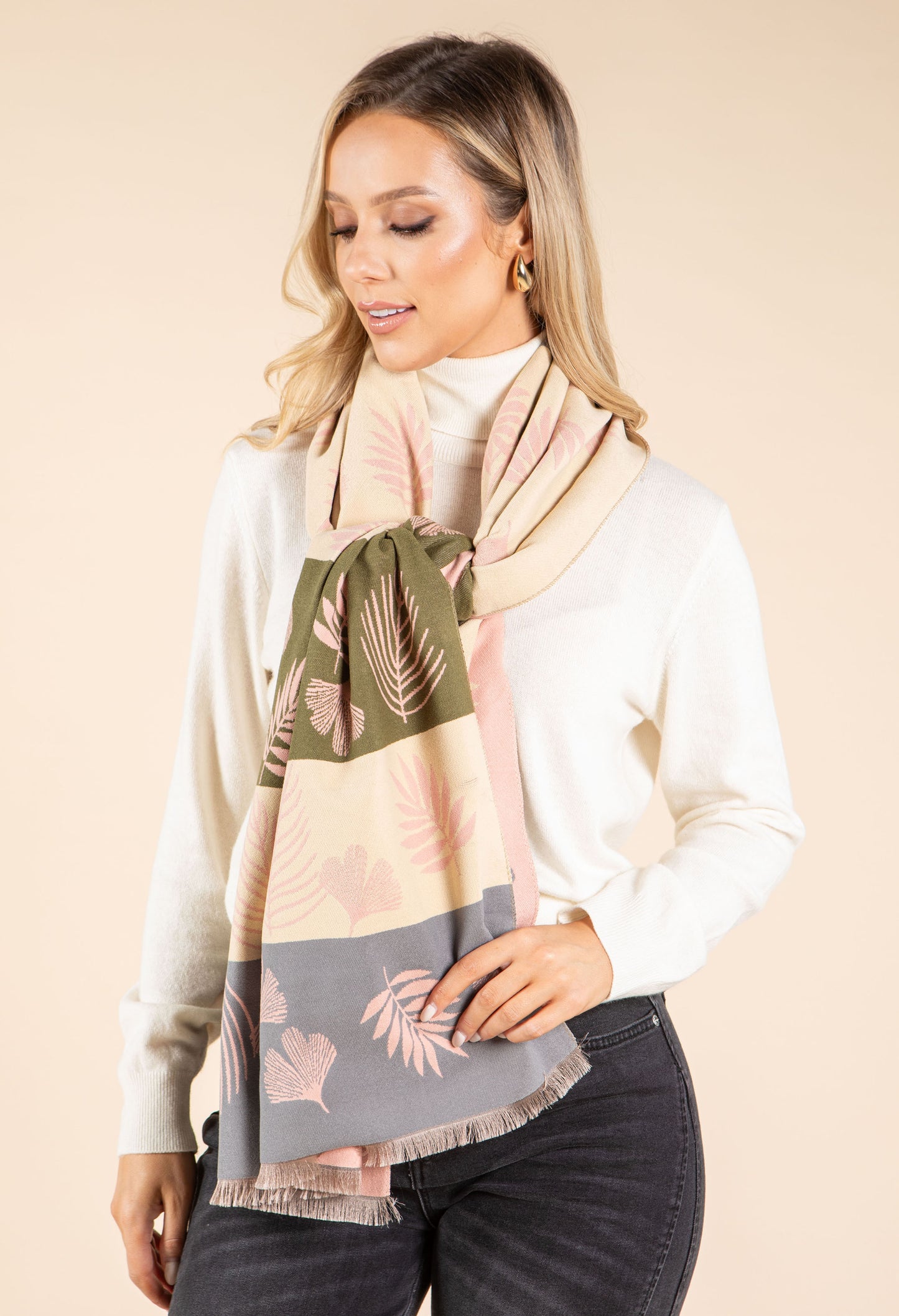 Woman wearing a patterned scarf with a neutral background