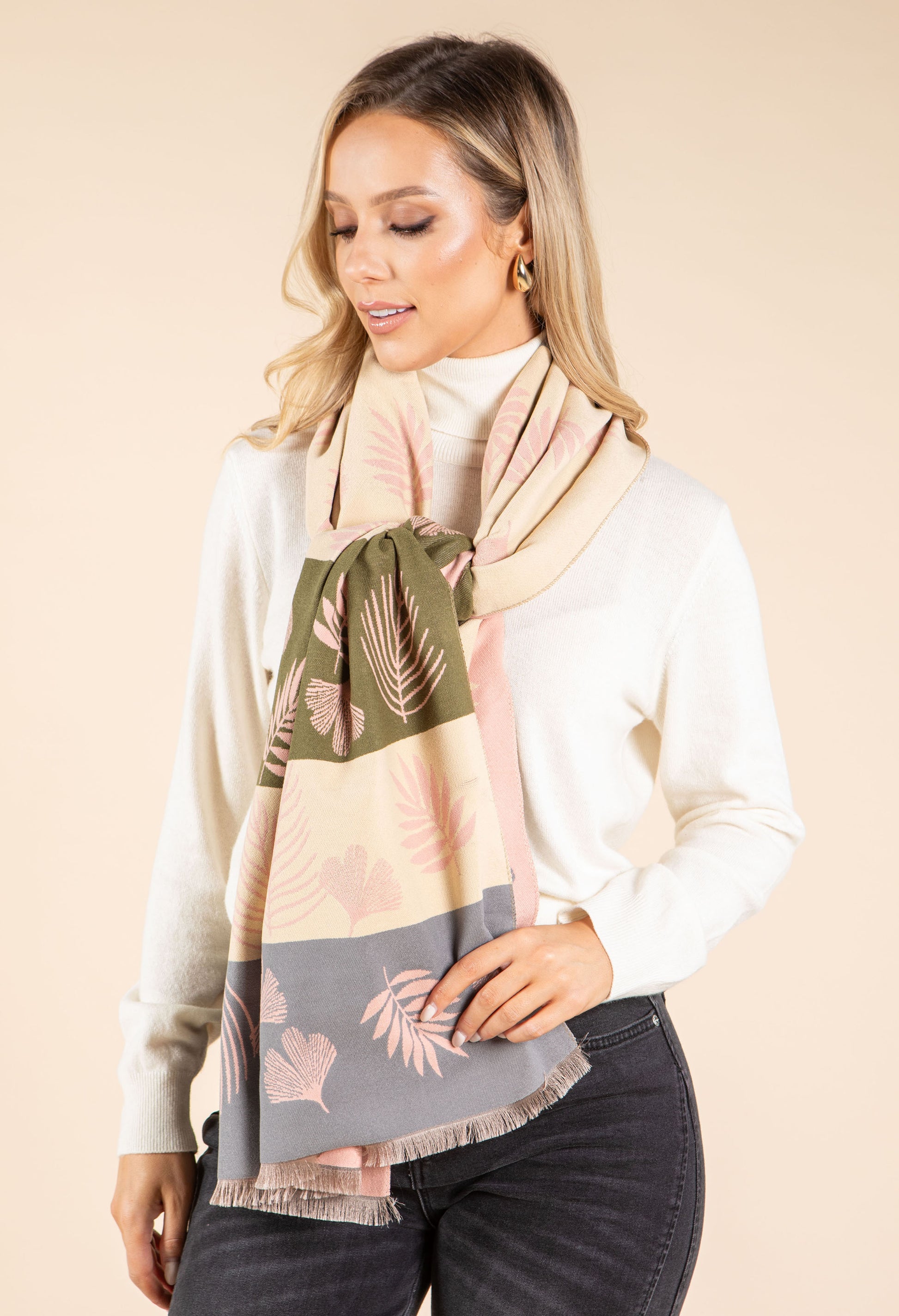 Woman wearing a patterned scarf with a neutral background