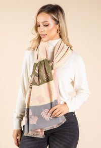 Woman wearing a patterned scarf with a neutral background