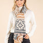 Woman wearing a patterned scarf with a beige background