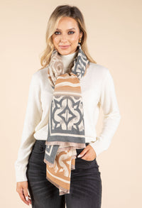Woman wearing a patterned scarf with a beige background