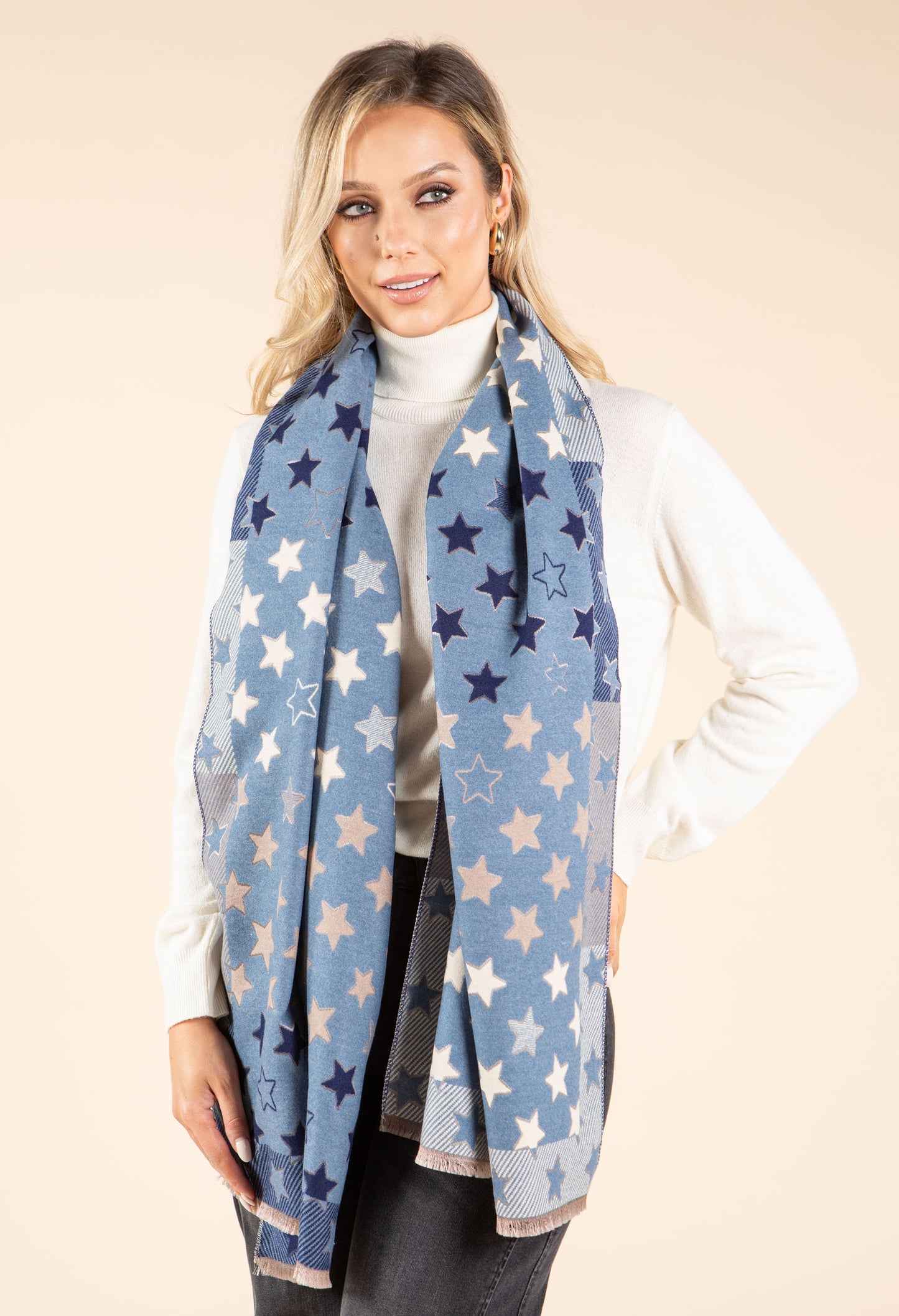 Woman wearing a blue star-patterned scarf on a beige background