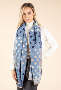 Woman wearing a blue star-patterned scarf on a beige background